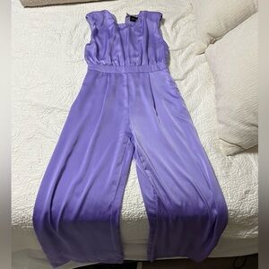 Purple dressy jumpsuit. Very comfortable with shoulder pads. Wide leg